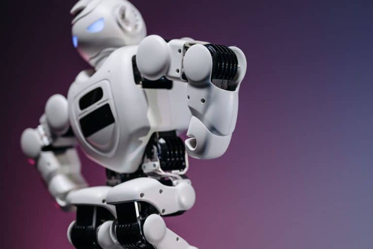 Robot futurista con articulaciones y pantalla en fondo morado.