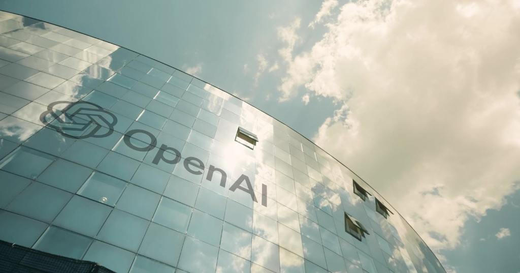 Edificio corporativo de OpenAI reflejando el cielo, representando la expansión publicitaria visual en ChatGPT